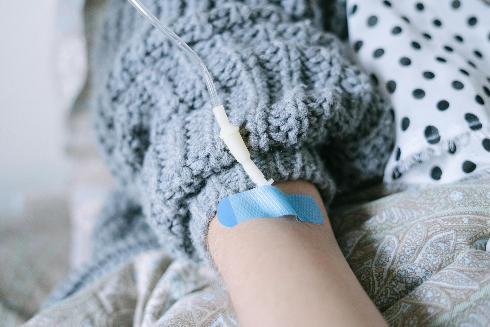Close-up of a patient receiving intravenous therapy during cancer treatment.